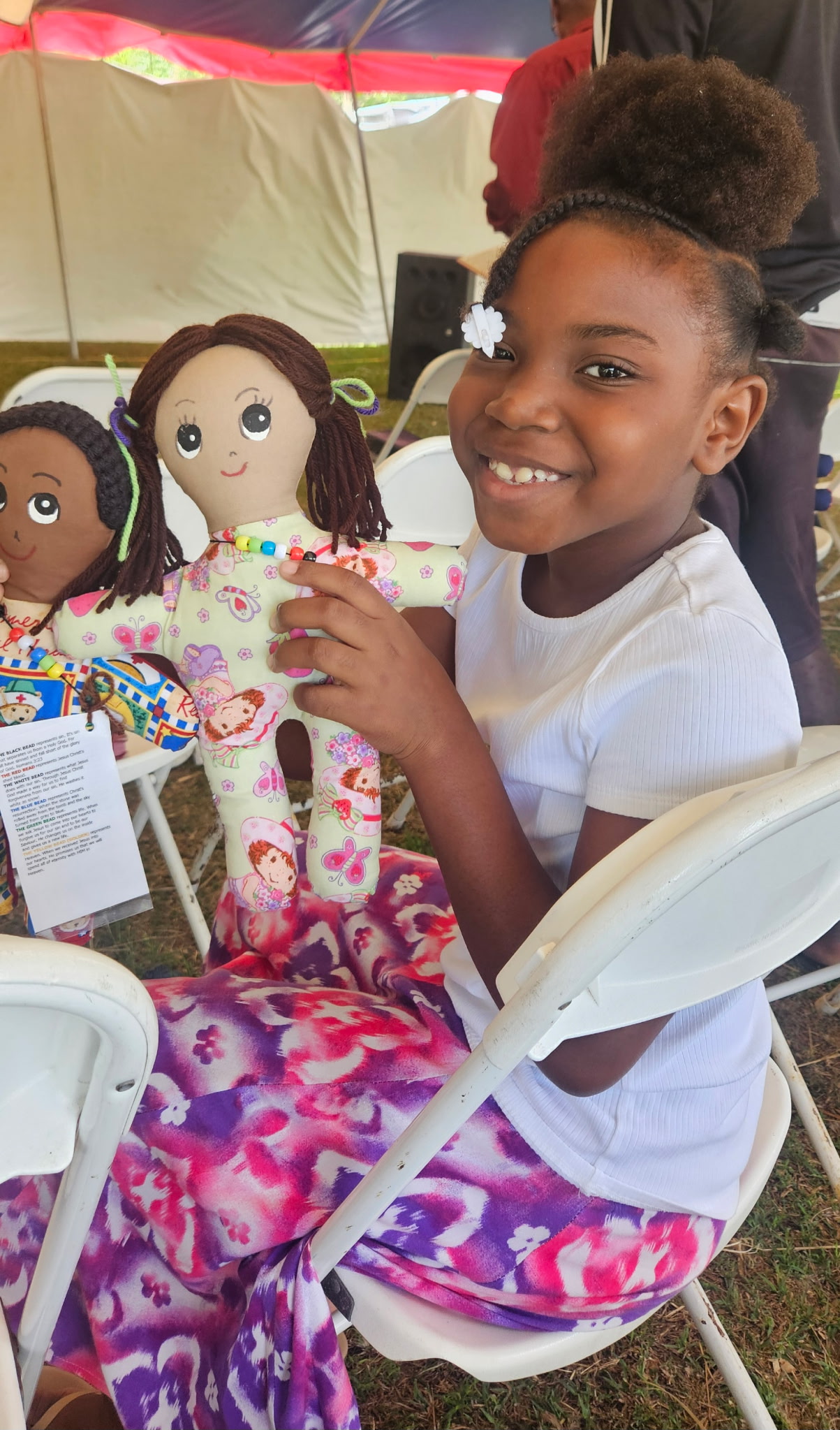 Picture of young girl holding a homemade doll