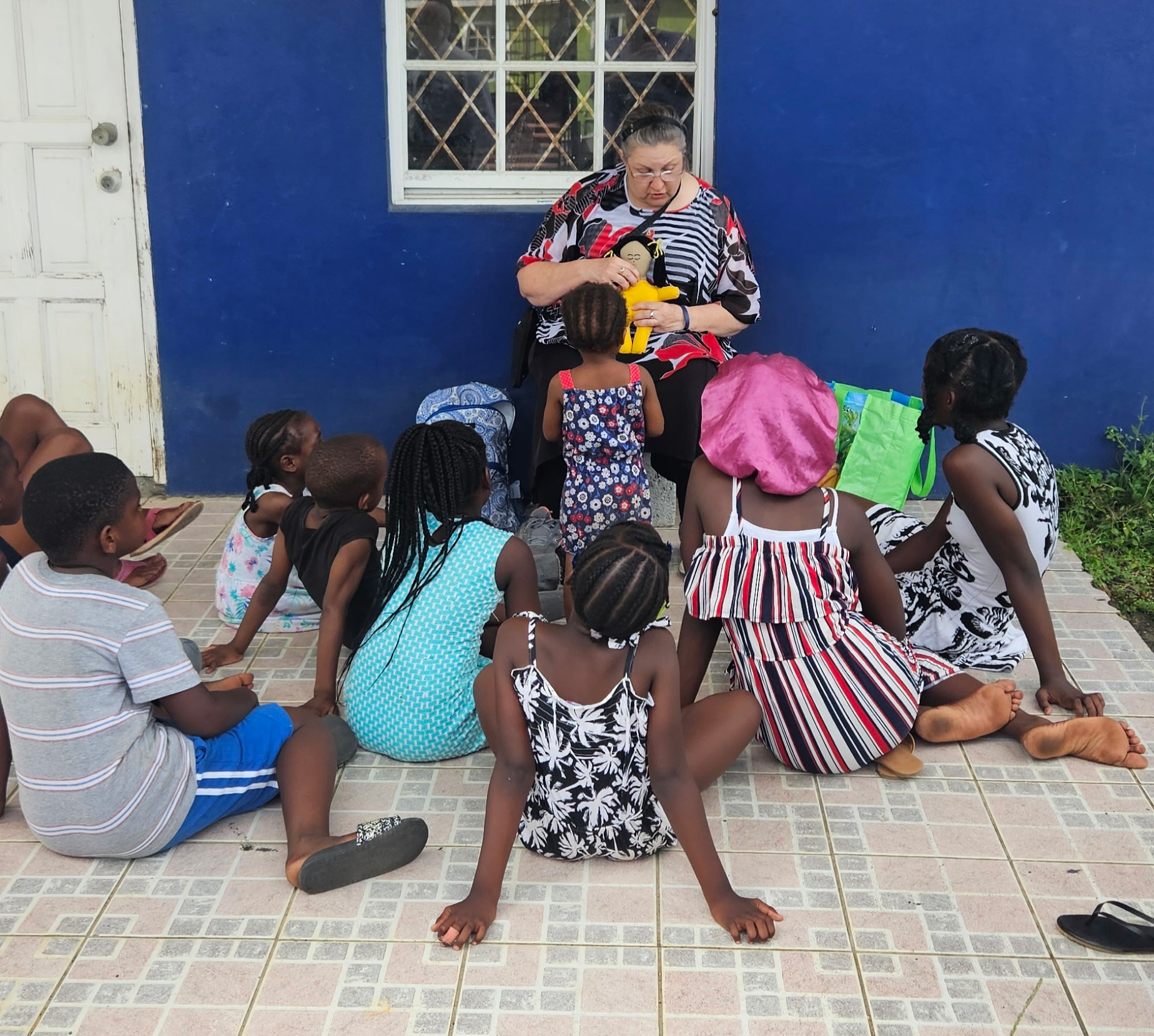 Picture of Joeth talking to a group of children