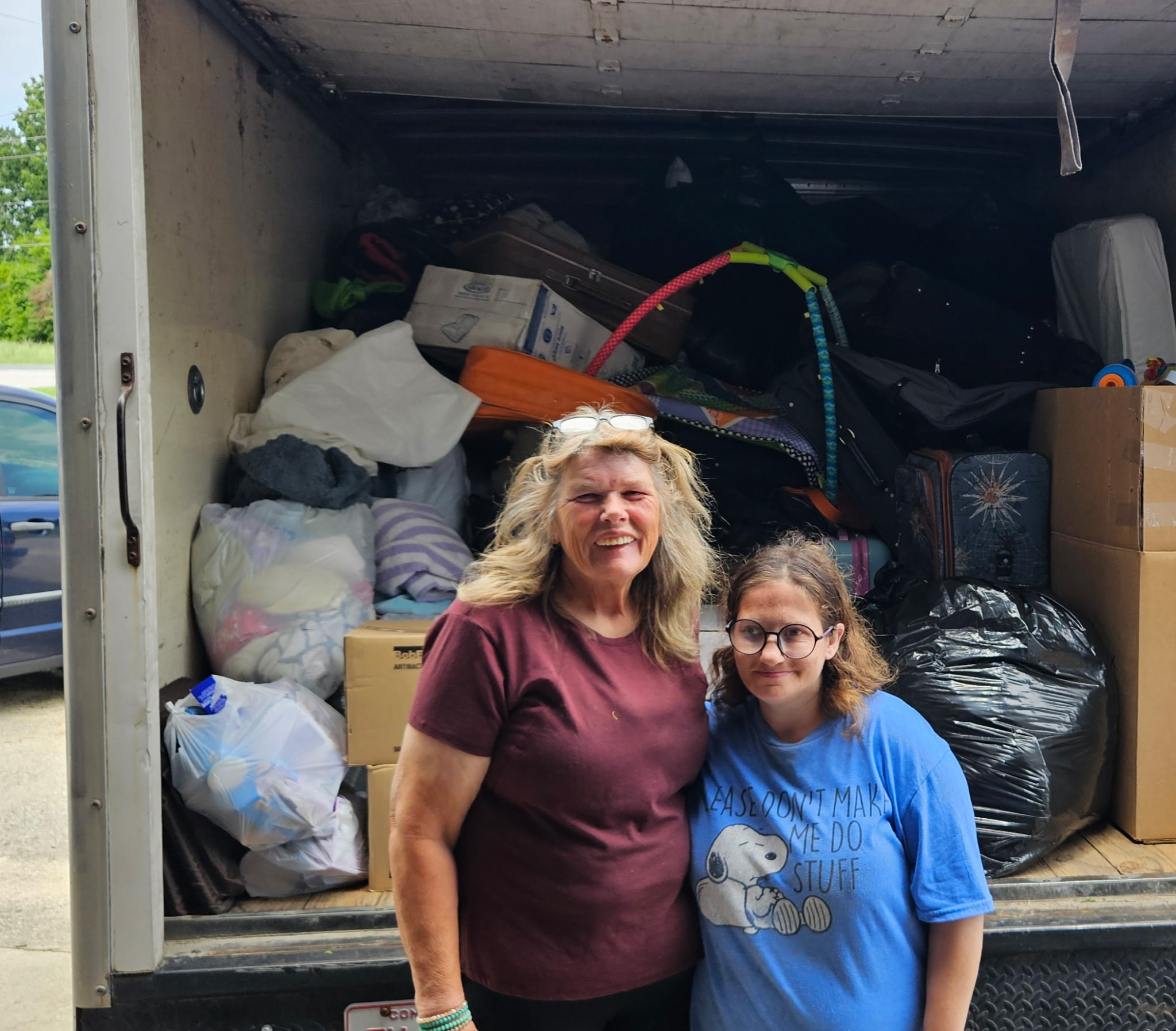 Picture of women standing in front of full box truck