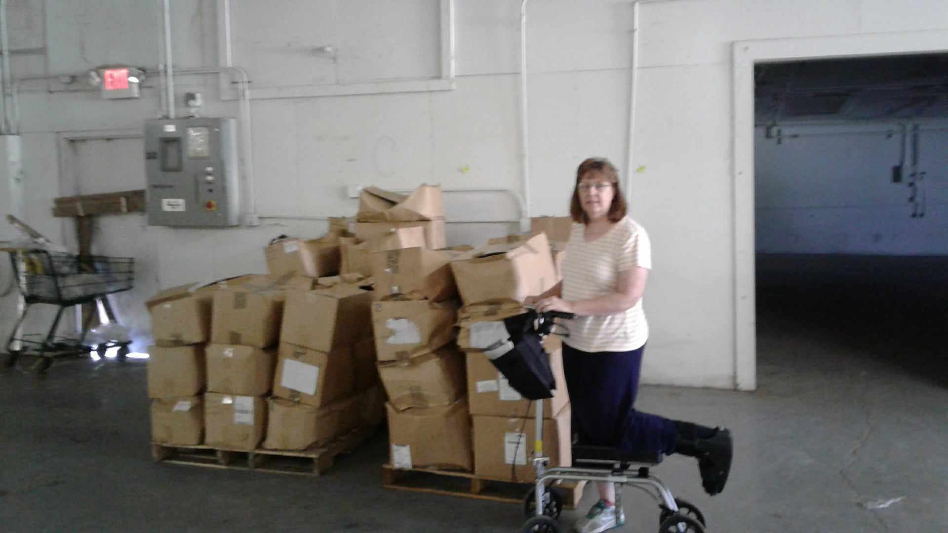 Picture of Joeth in front of boxes in the newly acquired warehouse